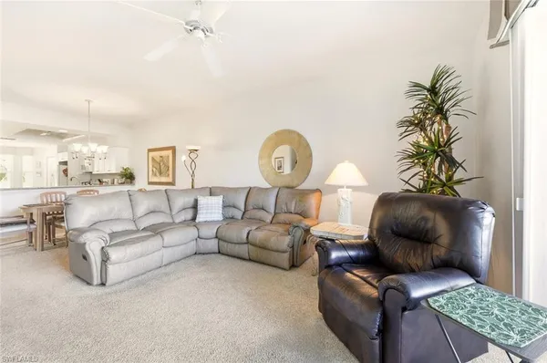 a living room with furniture and a lamp