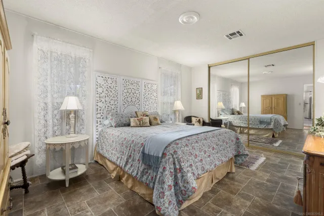 a bedroom with a bed and a mirror