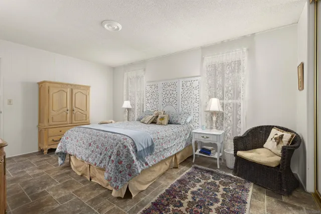 a bedroom with a bed couch and a window