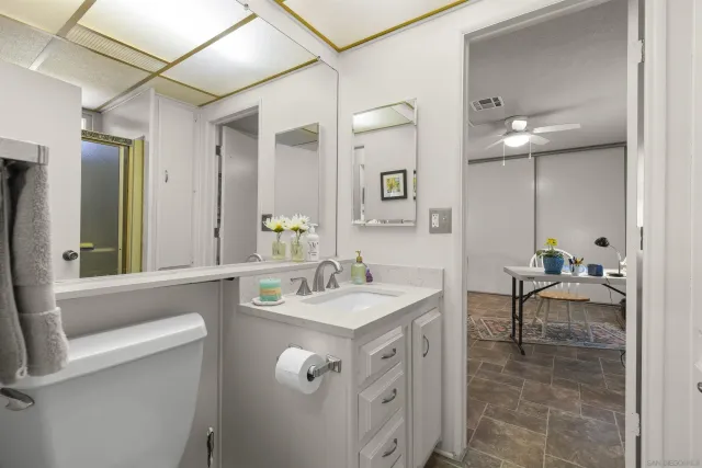 a bathroom with a sink a large mirror and a shower