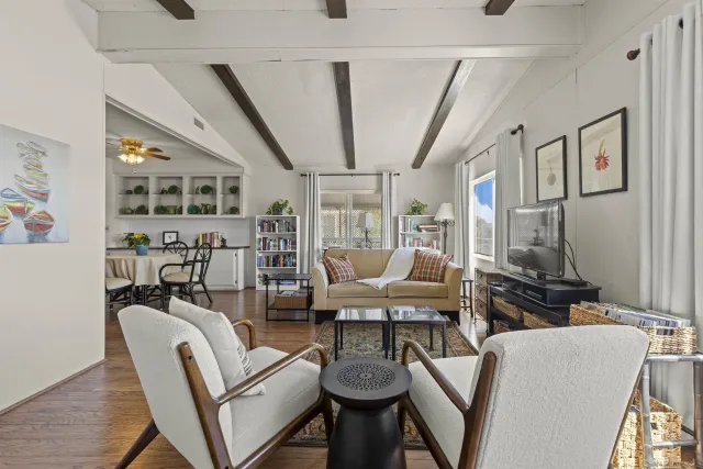a dining room with furniture and wooden floor