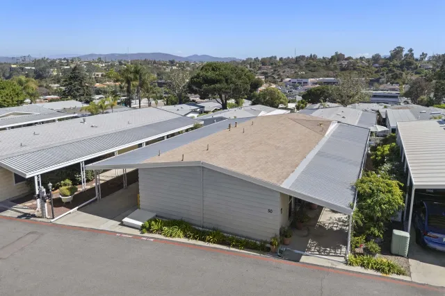 an aerial view of a house with a yard and lake view