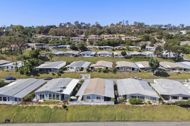 an aerial view of multiple houses with a big yard