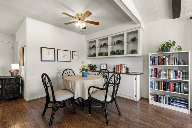 a view of a dining room with furniture and wooden floor