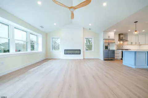 a kitchen with granite countertop a sink stainless steel appliances and cabinets