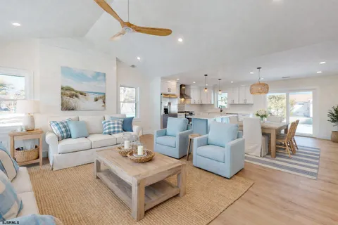 a large kitchen with stainless steel appliances kitchen island a large counter top and a refrigerator