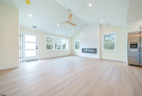 a kitchen with stainless steel appliances sink cabinets and wooden floor