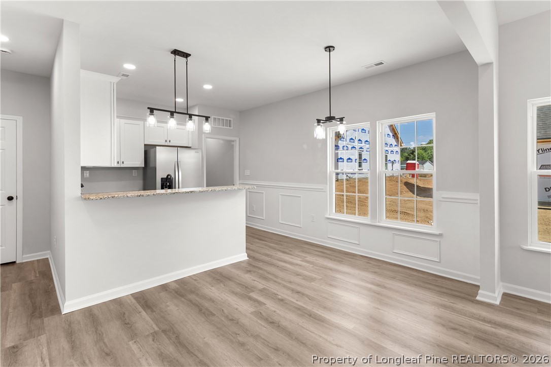 802 Holmes Street Clinton, NC 28328 - Photo 7 of 31 a view of a kitchen with a dishwasher cabinets and a wooden floor