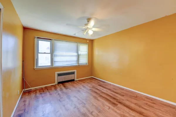 a view of workspace with wooden floor and fan