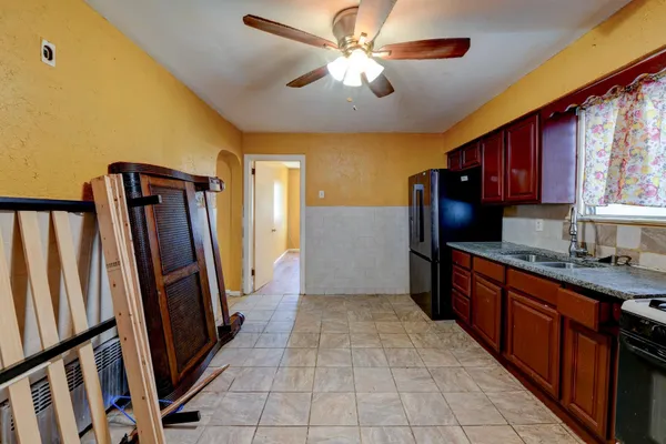 a kitchen with stainless steel appliances granite countertop a refrigerator a stove top oven a sink and dishwasher