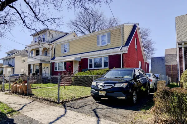 a view of a brick house with a yard