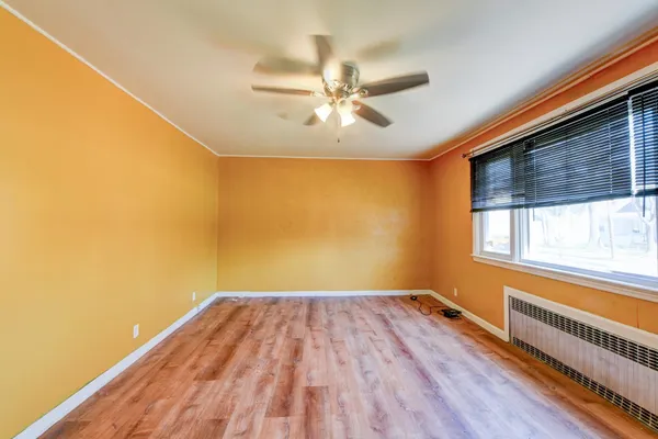a view of a big room with wooden floor closet and windows