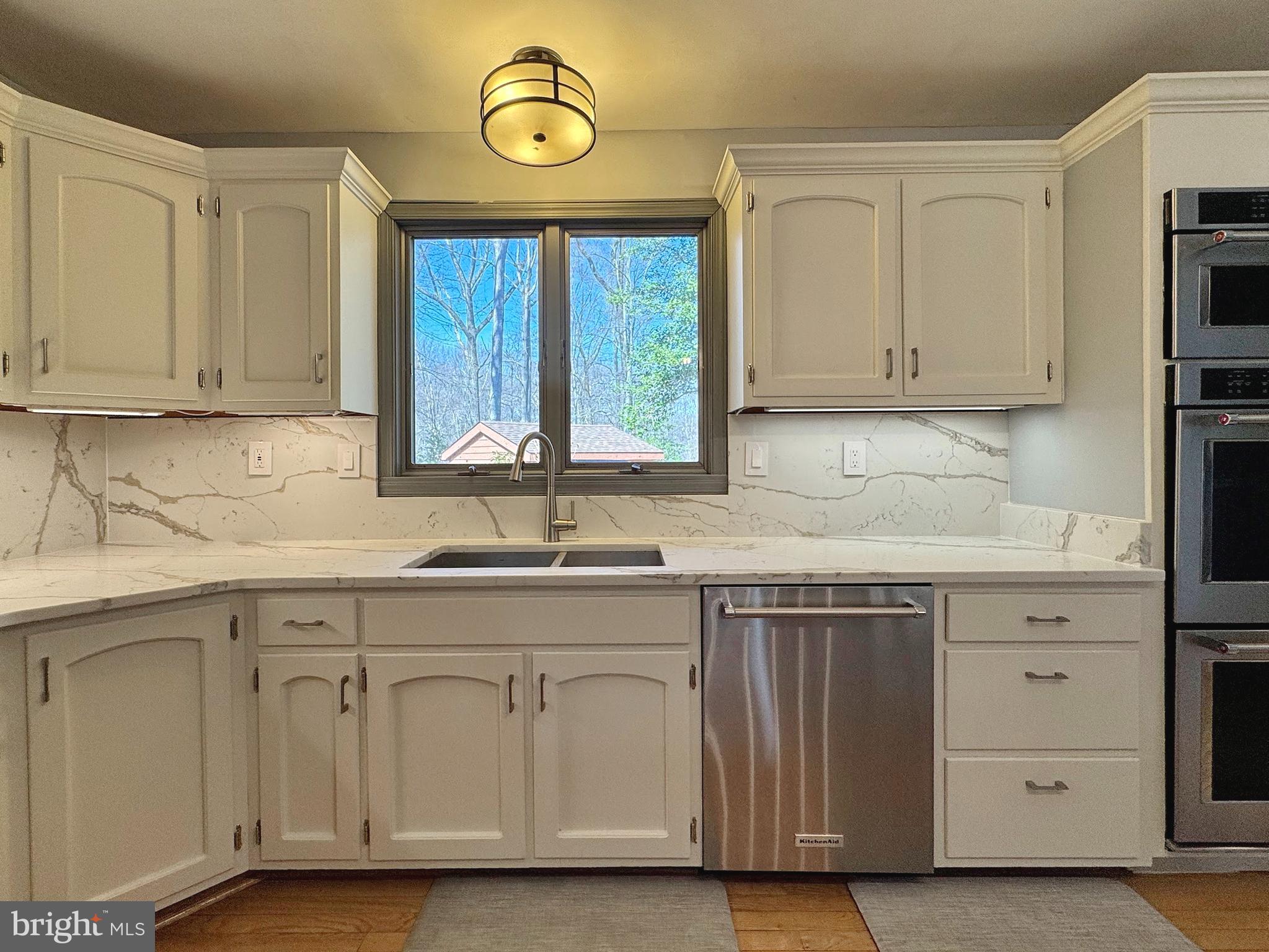 8150 Plowden Drive La Plata, MD 20646 - Photo 17 of 91 a kitchen with white cabinets and sink