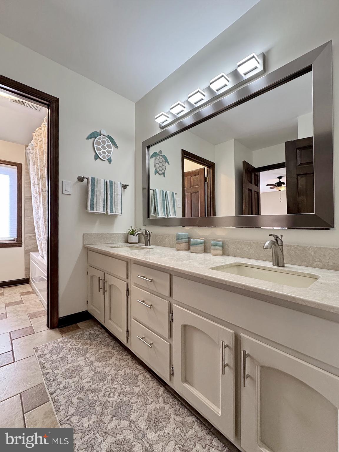 8150 Plowden Drive La Plata, MD 20646 - Photo 56 of 91 a spacious bathroom with a double vanity sink and a mirror