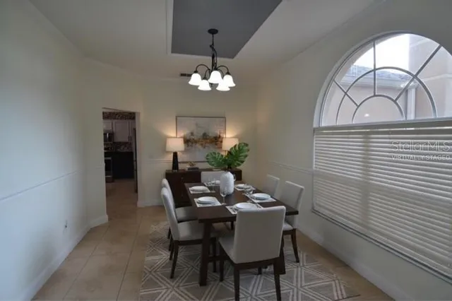 a view of a dining room with furniture and chandelier