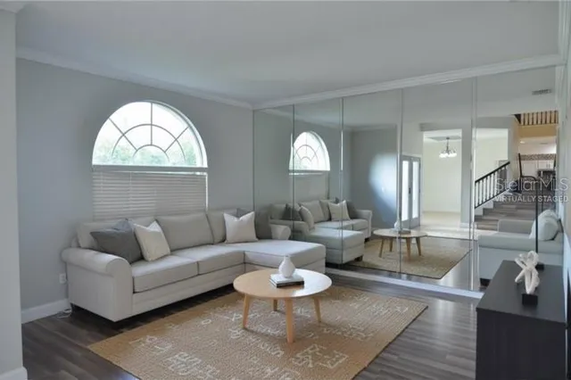 a living room with fireplace furniture and a large window