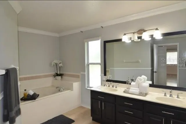 a kitchen with granite countertop a sink stainless steel appliances and white cabinets