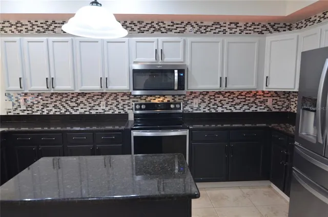 a view of staircase with lots of frames on wall and wooden floor