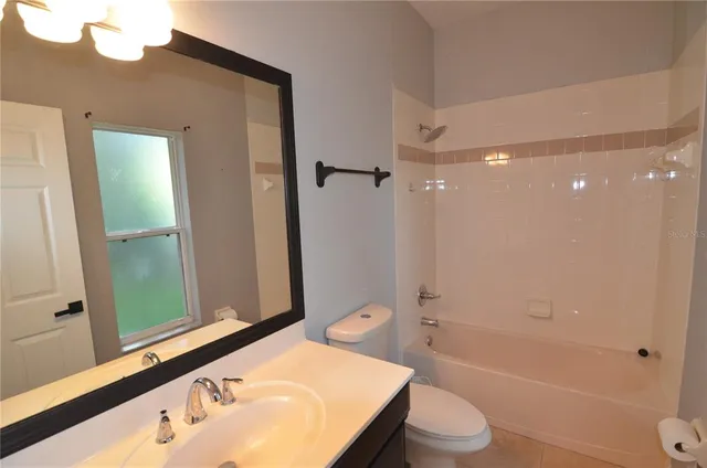 an empty room with wooden floor and entrance