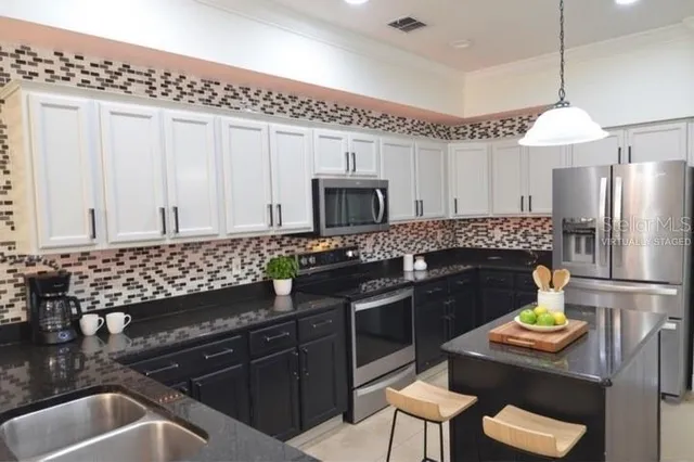 a kitchen with a sink appliances and cabinets