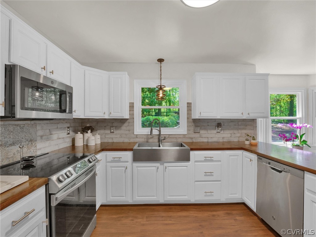 14307 Long Gate Road Midlothian, VA 23112 - Photo 14 of 41 a kitchen with a white stove top oven sink and cabinets