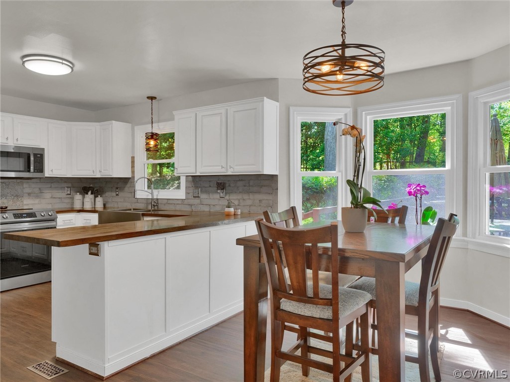 14307 Long Gate Road Midlothian, VA 23112 - Photo 15 of 41 a view of a dining room with furniture a chandelier and wooden floor