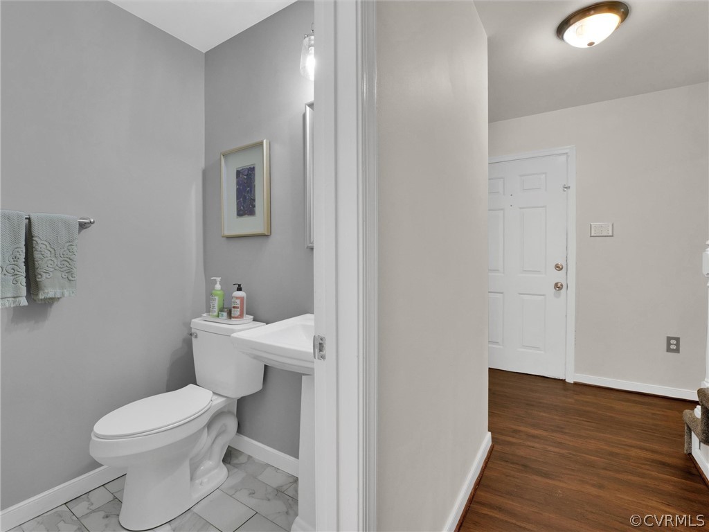 14307 Long Gate Road Midlothian, VA 23112 - Photo 10 of 41 a white toilet sitting next to a bathroom sink