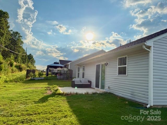 505 Grandiflora Avenue Lancaster, SC 29720 - Photo 12 of 16 a view of a patio with couches plants and large trees