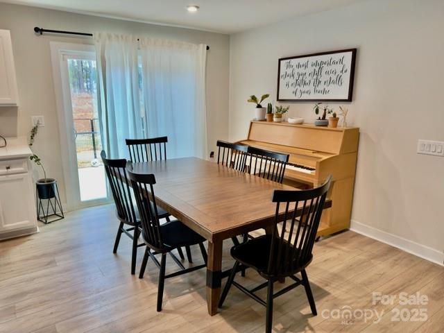 505 Grandiflora Avenue Lancaster, SC 29720 - Photo 3 of 16 a view of a dining room with furniture and wooden floor