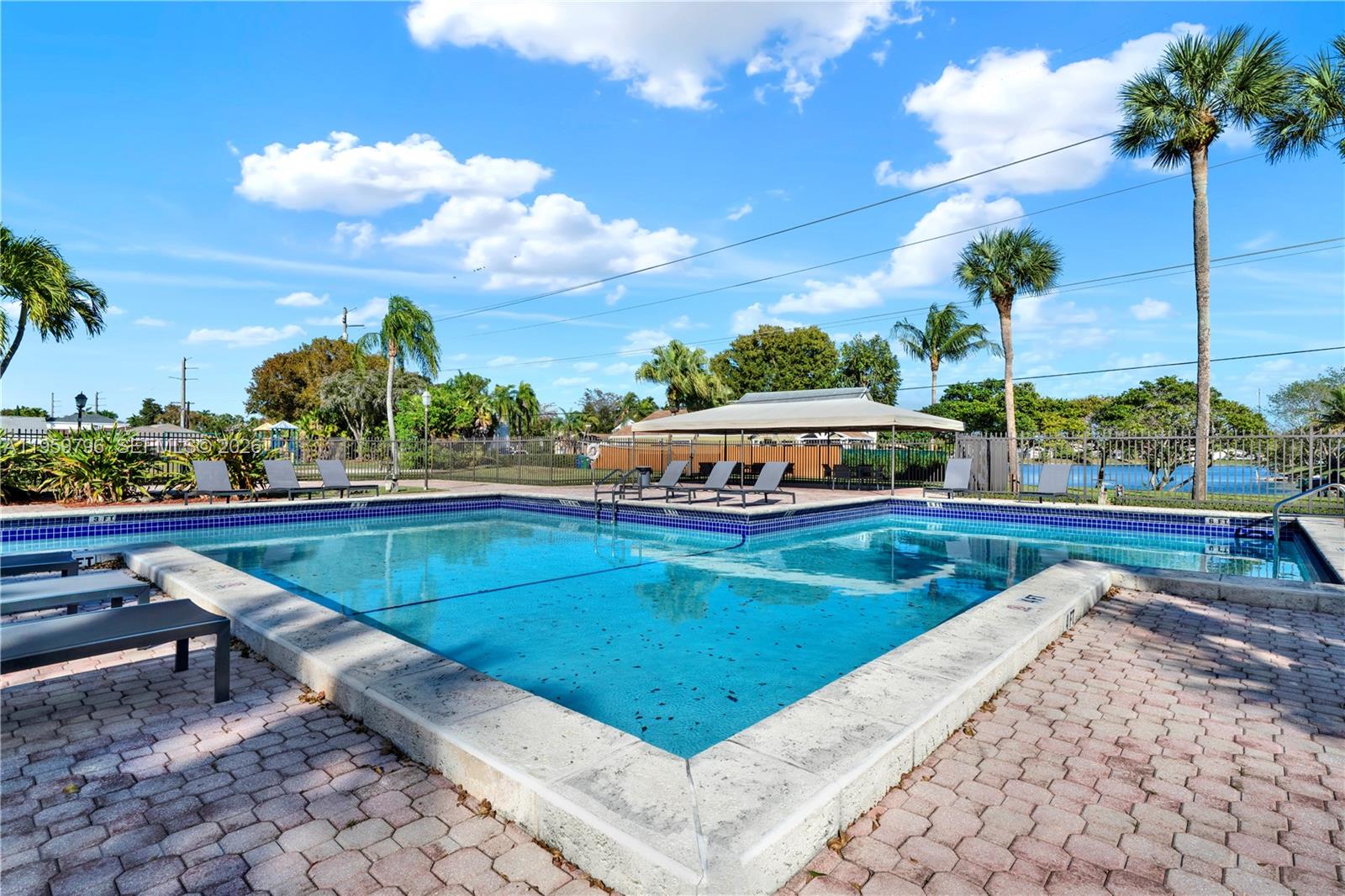 14600 Southwest 124th Place Miami, FL 33186 - Photo 25 of 34 a view of a swimming pool with a lounge chairs