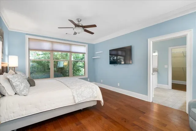 a large bed sitting in a bedroom next to a window