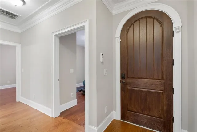 a room with a wooden floor and potted plant