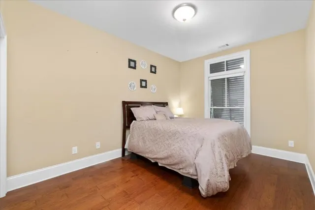 a bathroom with a granite countertop sink toilet a large mirror a bathtub and shower