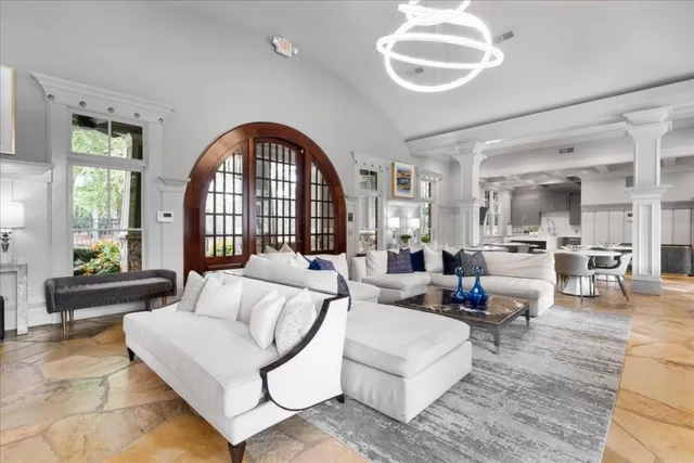 a living room with furniture and a lamp