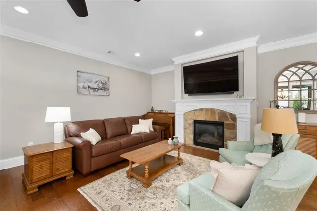 a living room with furniture a fireplace and a flat screen tv
