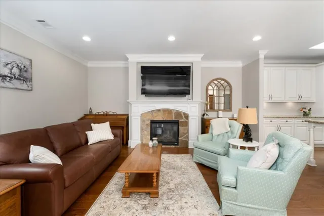 a living room with furniture fireplace and flat screen tv