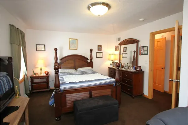 a bedroom with furniture and a window