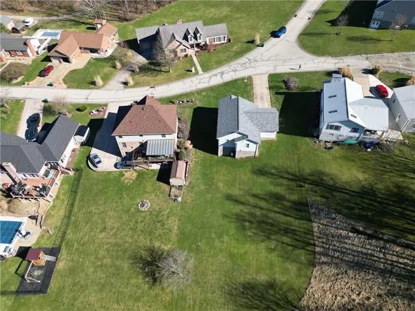 aerial view of a house with a yard