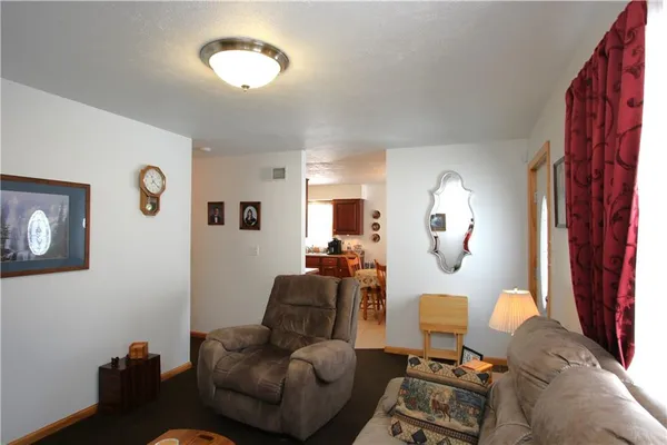 a living room with furniture and a mirror