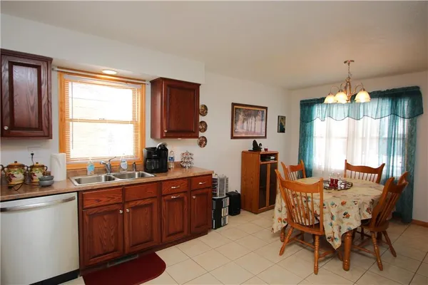 a dining room with furniture a window and kitchen view