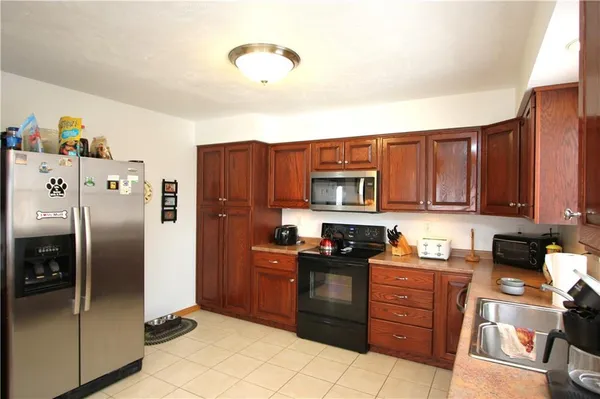 a kitchen with stainless steel appliances granite countertop a refrigerator stove and sink