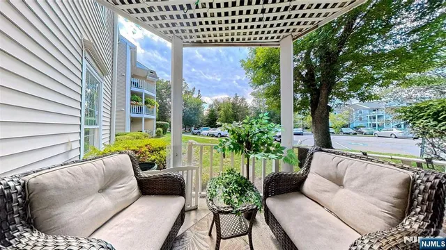 a balcony with furniture and a potted plant