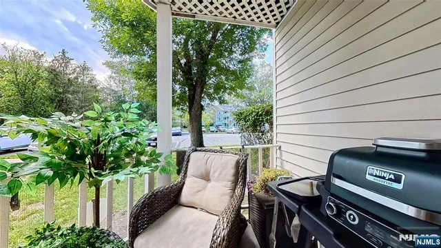 a view of a patio with table and chairs with wooden floor and fence