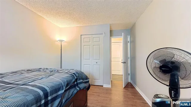 a bedroom with a bed and a mirror