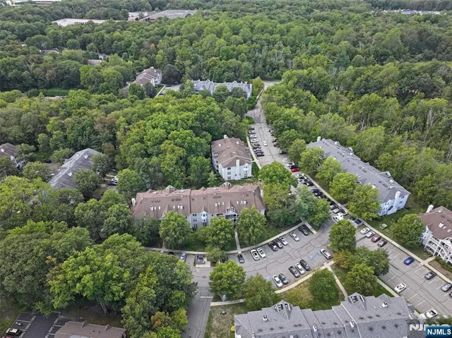 an aerial view of multiple houses with yard