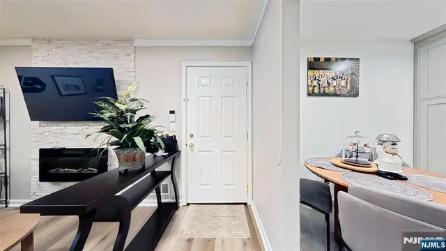 a living room with furniture fireplace and wooden floor