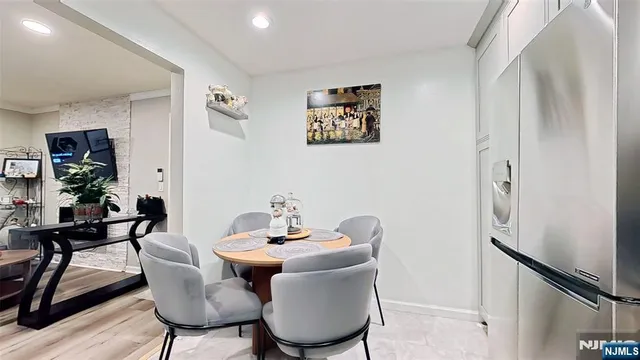 a dining room with furniture and wooden floor