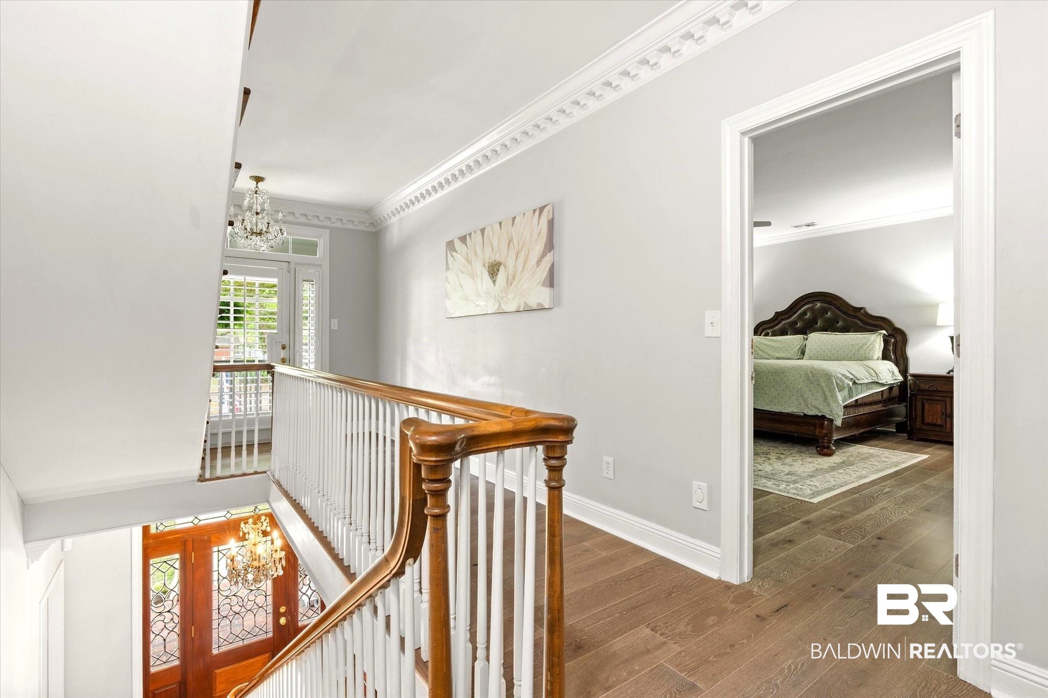 5324 Oak Bend Court Mobile, AL 36609 - Photo 18 of 49 Corridor featuring crown molding, an inviting chandelier, and an upstairs landing