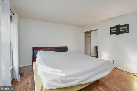 a bedroom with a bed and a night stand