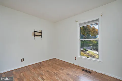 a view of room with window and hardwood floor